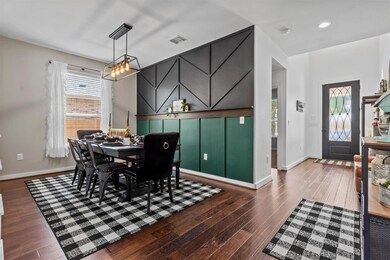 Dining space with hardwood / wood-style flooring,
