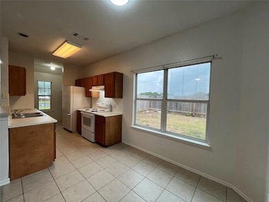Kitchen with white appliances, under cabinet rang