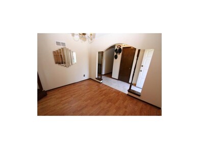 Dining Room has laminate flooring, pretty arch ope