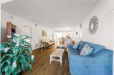 Living room with wood finished floors, visible ven