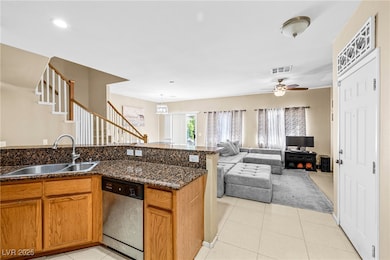 Kitchen featuring dishwasher, a sink, a ceiling fa