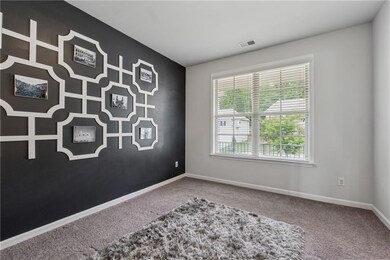 Empty room featuring carpet flooring and baseboards