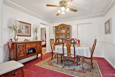 Carpeted dining area with crown molding and a ceil