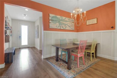 Dining area featuring an inviting chandelier, wain
