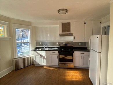 Renovated kitchen with upgraded plumbing, electric, and new stainless steel oven/range and backsplash