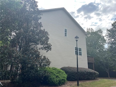 View of side of property featuring a wooden deck