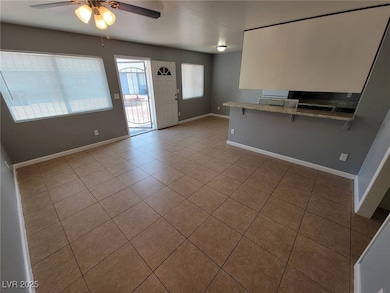 Unfurnished living room featuring ceiling fan and