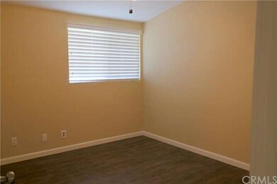 BEDROOM WITH LAMINATE FLOORS AND CEILING FAN