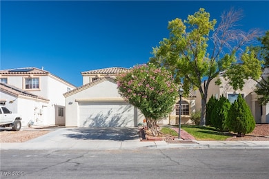 Mediterranean / spanish home with concrete driveway, an attached garage, and stucco siding