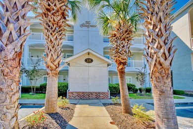 View of exterior entry with a balcony