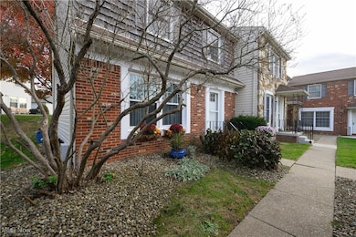 View of front of house with brick siding and mansard roof