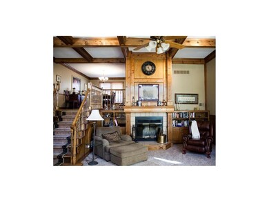 Great Room with soaring fireplace and master woodw
