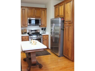 Kitchen has wood flooring, center island and dinet