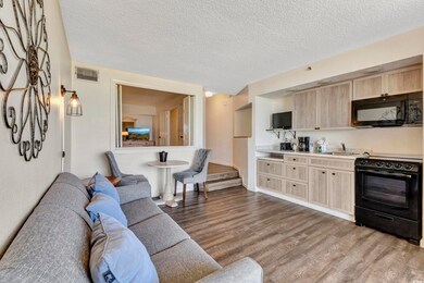 Living room featuring a textured ceiling, visible 