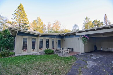 Front view of property featuring a yard and a carp