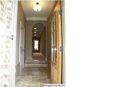 Covered entrance with glass pane door.