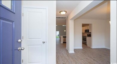 Entryway featuring visible vents, light wood-type 