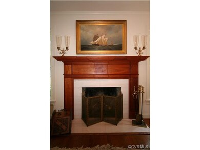 Living room features custom handmade cherry mantel