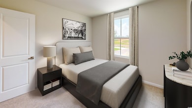 Bedroom with light colored carpet and baseboards