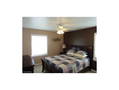 First Floor Bedroom #1  Tastefully two tone wall paint, lighted ceiling paddle fan, neutral carpeting