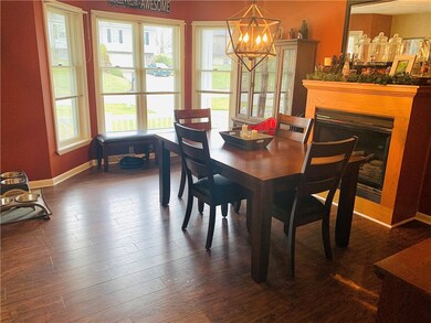 Dining room with bow window and gas fireplace.