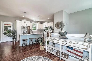 Kitchen featuring white cabinets, dark wood-style 