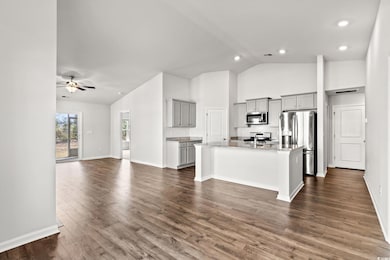 Kitchen featuring a center island with sink, gray 