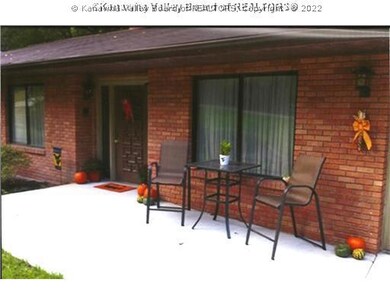 Exterior Front. Sitting area by front door.