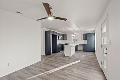 Kitchen featuring ceiling fan with notable chandel