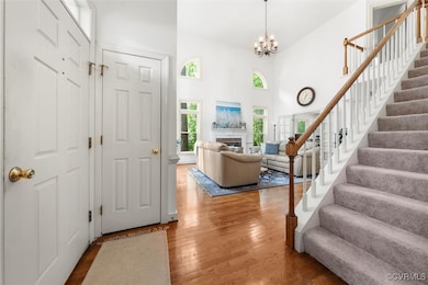 Entrance foyer with an inviting chandelier, a high