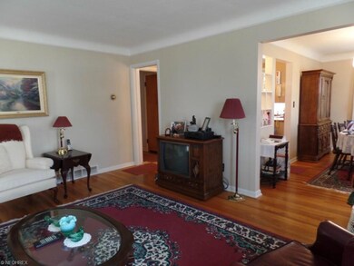 Beautiful hardwood throughout. Living room looking to dining room and hall to bedrooms.