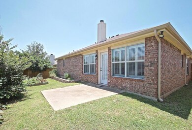 Rear view of house featuring a patio area and a ya