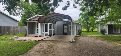 Front of the home, with carport and workshop on th
