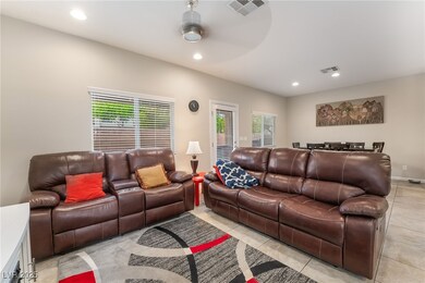 Living room with recessed lighting, light tile pat