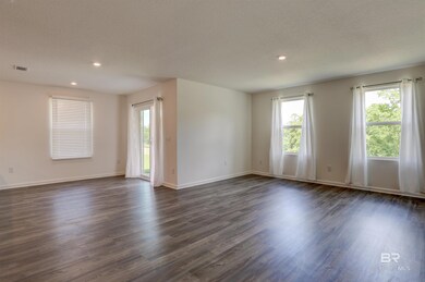 Unfurnished room featuring dark hardwood / wood-style floors and a textured ceiling