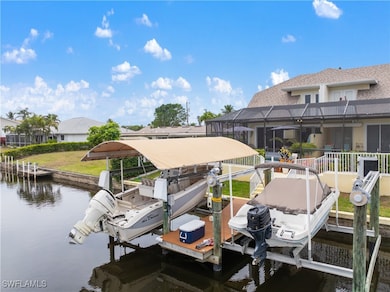 Dock area featuring boat lift and a water view