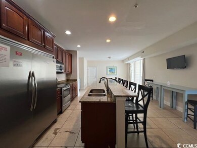 Kitchen with light tile patterned floors, stainles
