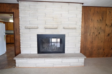 The focal point of the room is the brick fireplace.  This is a wood burning unit.  A unique features is the fireplace is double sided, allowing you to enjoy the fire from the dining room and the living room.