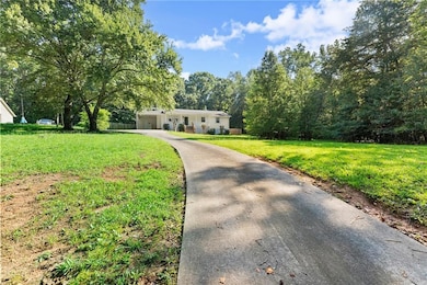 Ranch-style house with driveway and a front yard