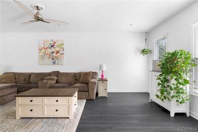 Unfurnished living room featuring dark wood-type f