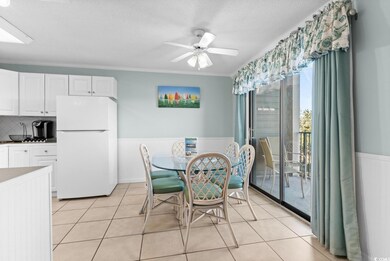 Tiled dining space featuring a textured ceiling, o