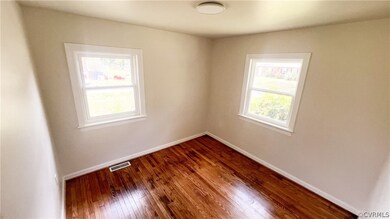 Unfurnished room with hardwood / wood-style flooring
