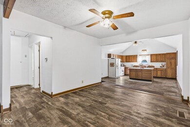 Living room stretches on where you could continue lounging or have a space for sitting chairs and a table perfect for reading or studying.