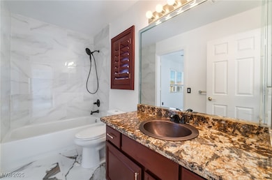 Bathroom featuring marble finish floor, vanity, to