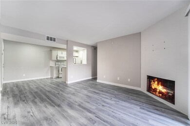 Unfurnished living room featuring a large fireplace and light hardwood / wood-style floors