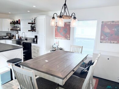 Dining space with recessed lighting and dark wood-style flooring