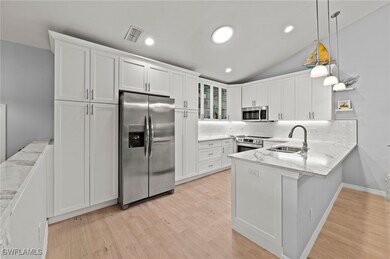 Kitchen with stainless steel appliances, hanging l