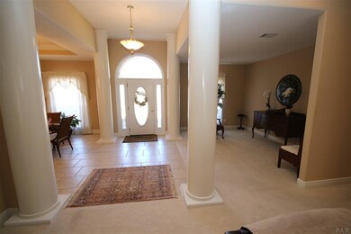 large beautiful columns & tile flooring.