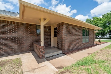 Property entrance featuring brick siding