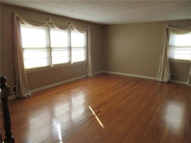 The living room boasts lots of natural light and stunning original hardwood floors!